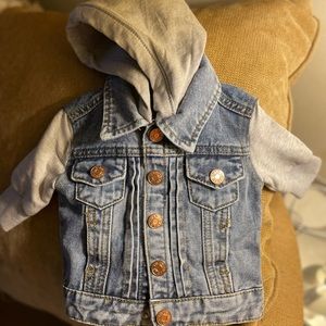 Jean jacket with gray sweatsuit material hood and sleeves. Warn one time.